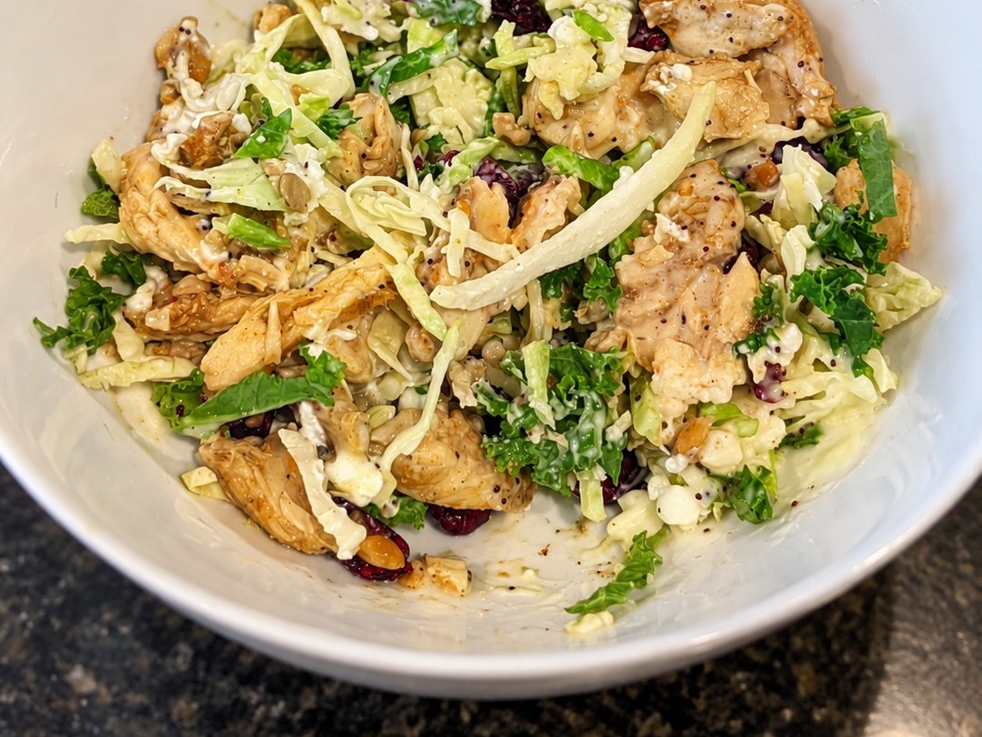 Taylor Farms Sweet Kale chopped salad topped with prepackaged chicken shawarma in a white bowl.