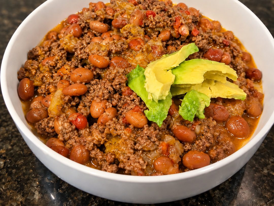 Ground-beef version of the Easy Protein Bowl topped with sliced avocado in a white bowl.